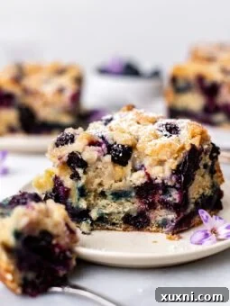Plate of vegan blueberry buckle with a bite taken from it