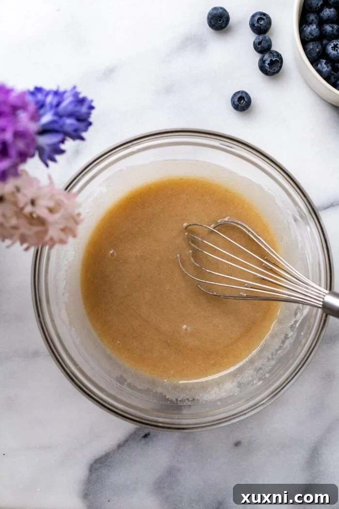 Wet ingredients for blueberry buckle batter being whisked