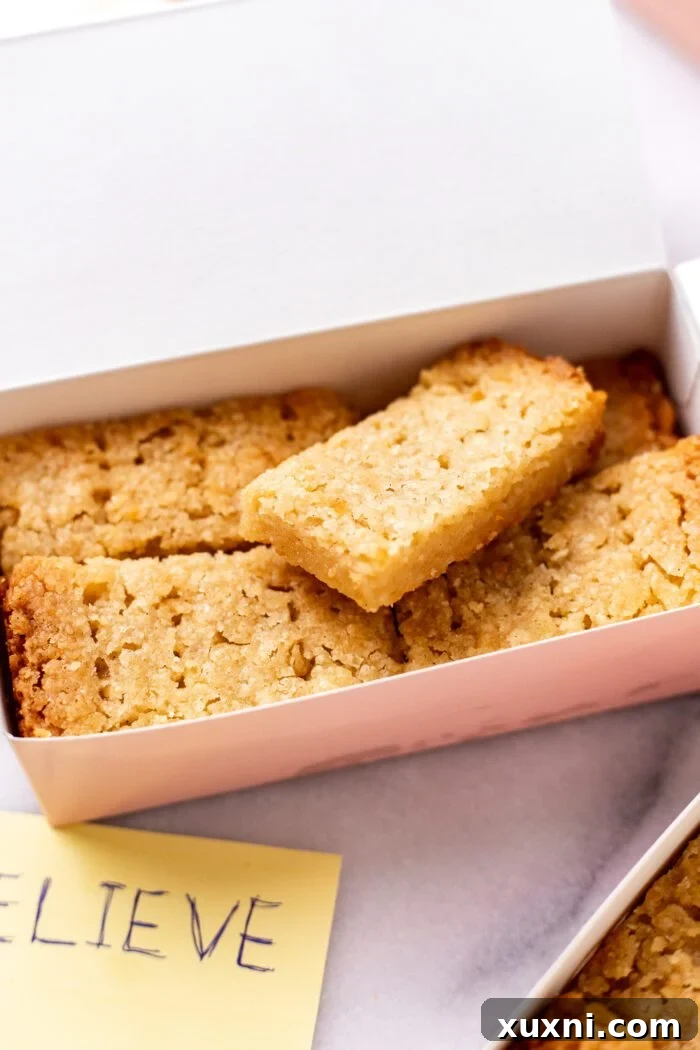 Buttery vegan shortbread biscuits arranged in a pink box, inspired by Ted Lasso.