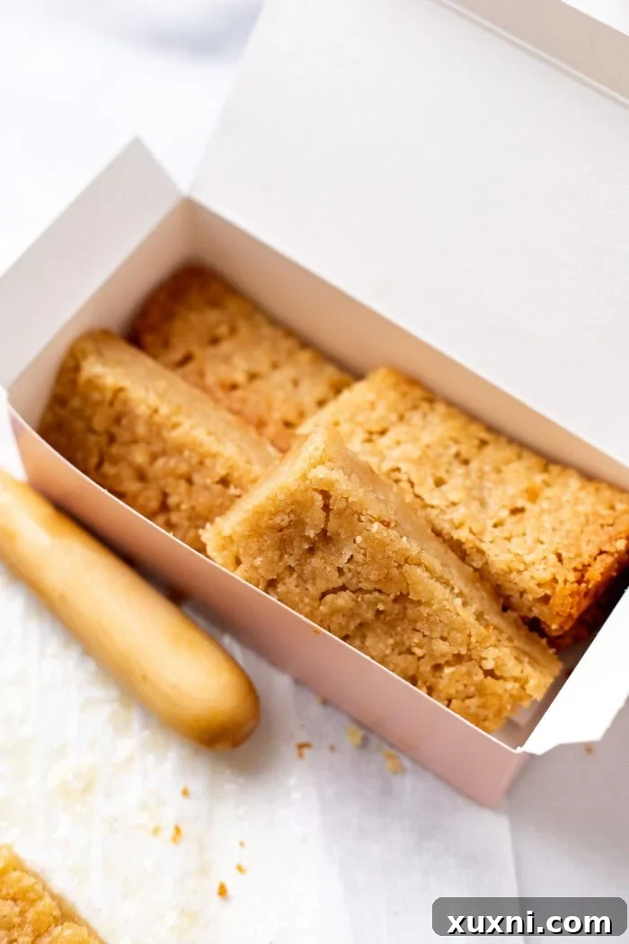 Vegan shortbread biscuits nestled perfectly in a pink box, ready to be gifted.