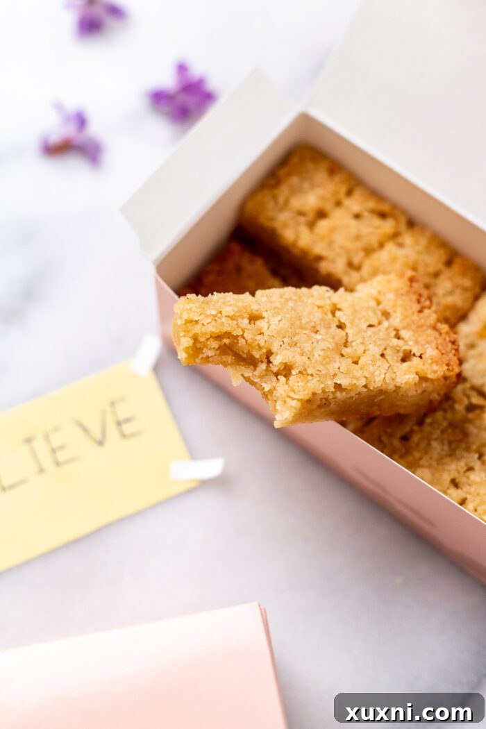 A partially eaten vegan Ted Lasso biscuit, showing its tender, buttery texture.