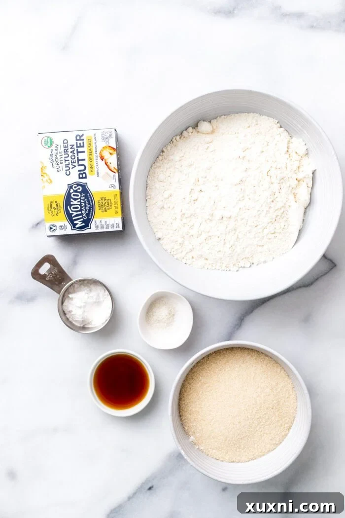 All the dry and wet ingredients for vegan shortbread biscuits laid out before mixing.