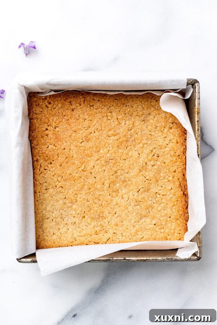 Golden-baked shortbread still in the pan, cooling.