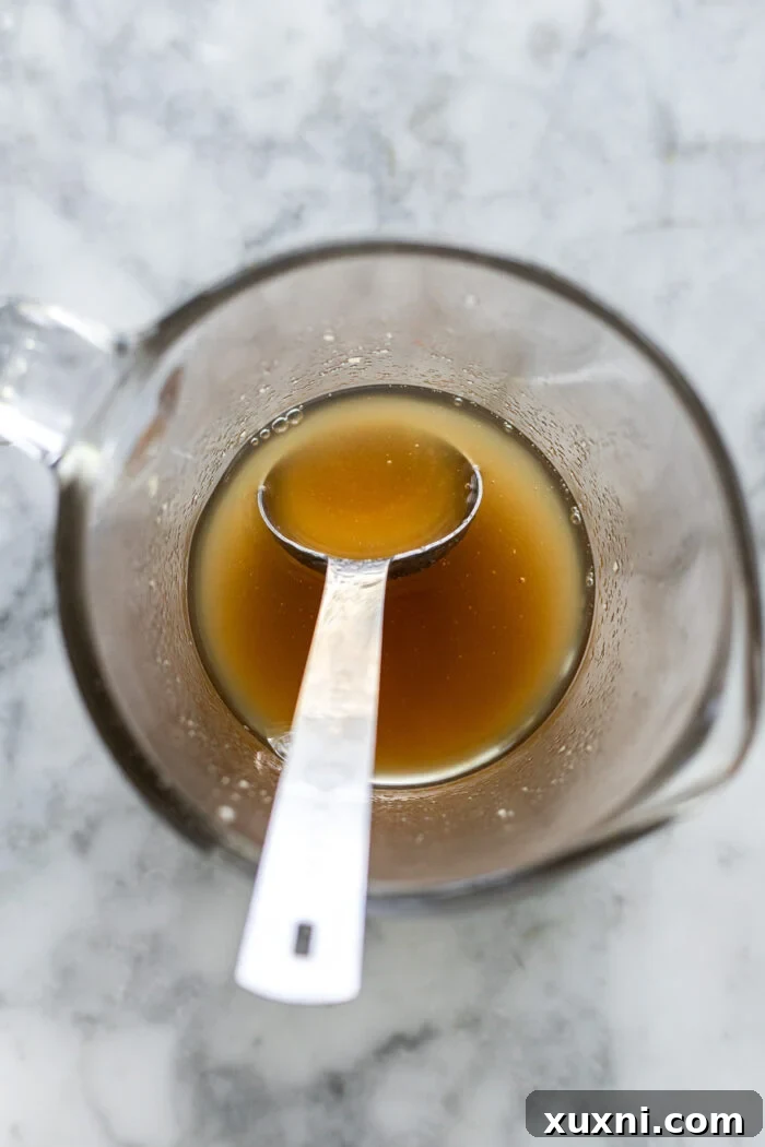 Close-up of browned vegan butter in a saucepan, showing the golden-brown flecks and rich color
