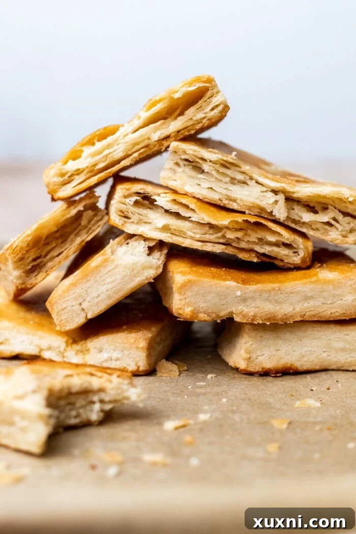 Layers of homemade gluten-free vegan puff pastry stacked beautifully, showcasing its flaky texture.