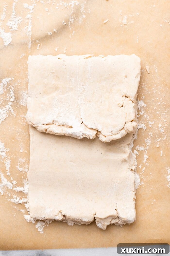 First fold of the puff pastry dough, folding the top third down.