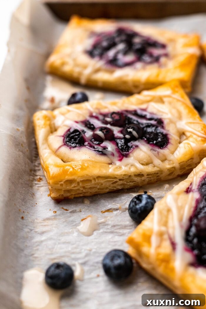 Close-up of a perfectly flaky vegan Danish pastry, showcasing its golden crust and tender layers.