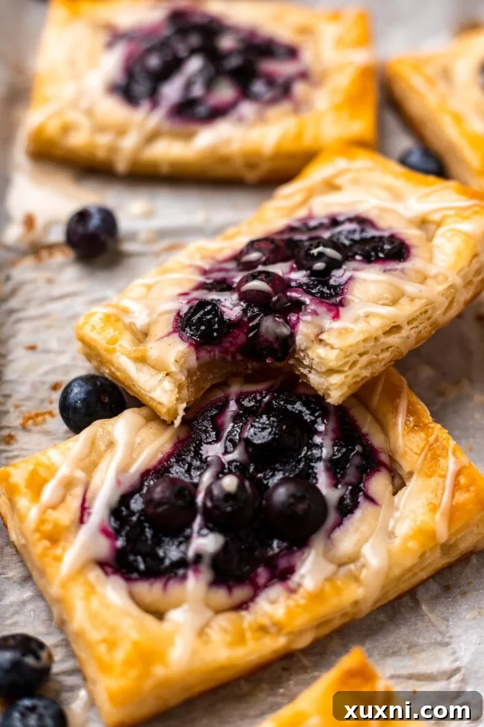 A delectable vegan puff pastry with a bite taken out, revealing its flaky layers and inviting filling.