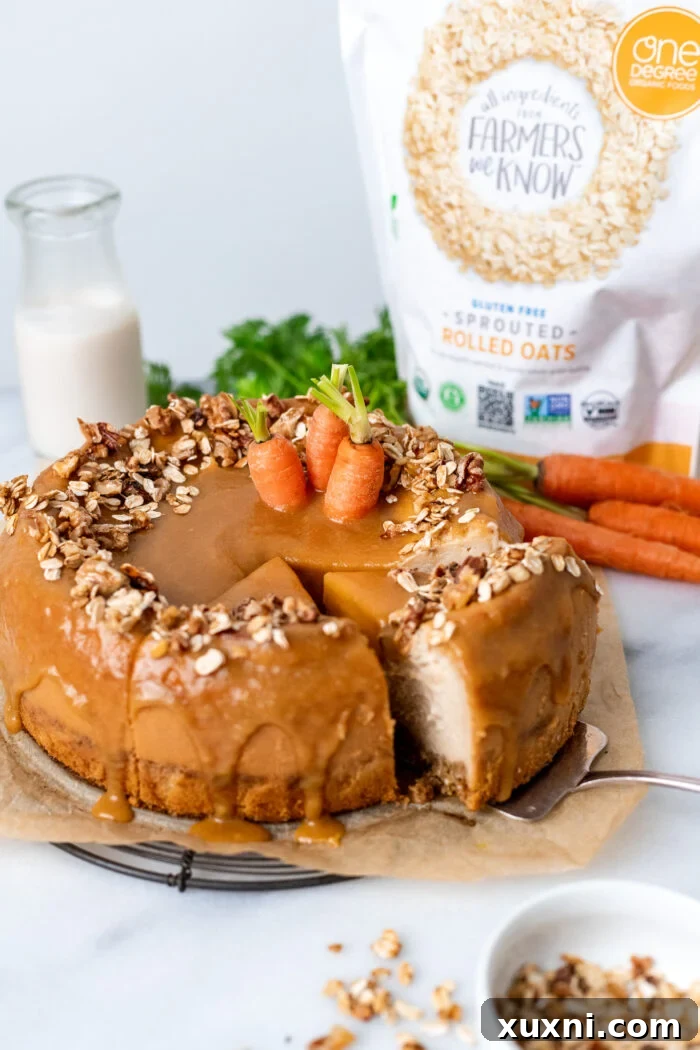 Two beautiful slices of vegan carrot cake cheesecake, with a bag of One Degree Organic Oats in the background.