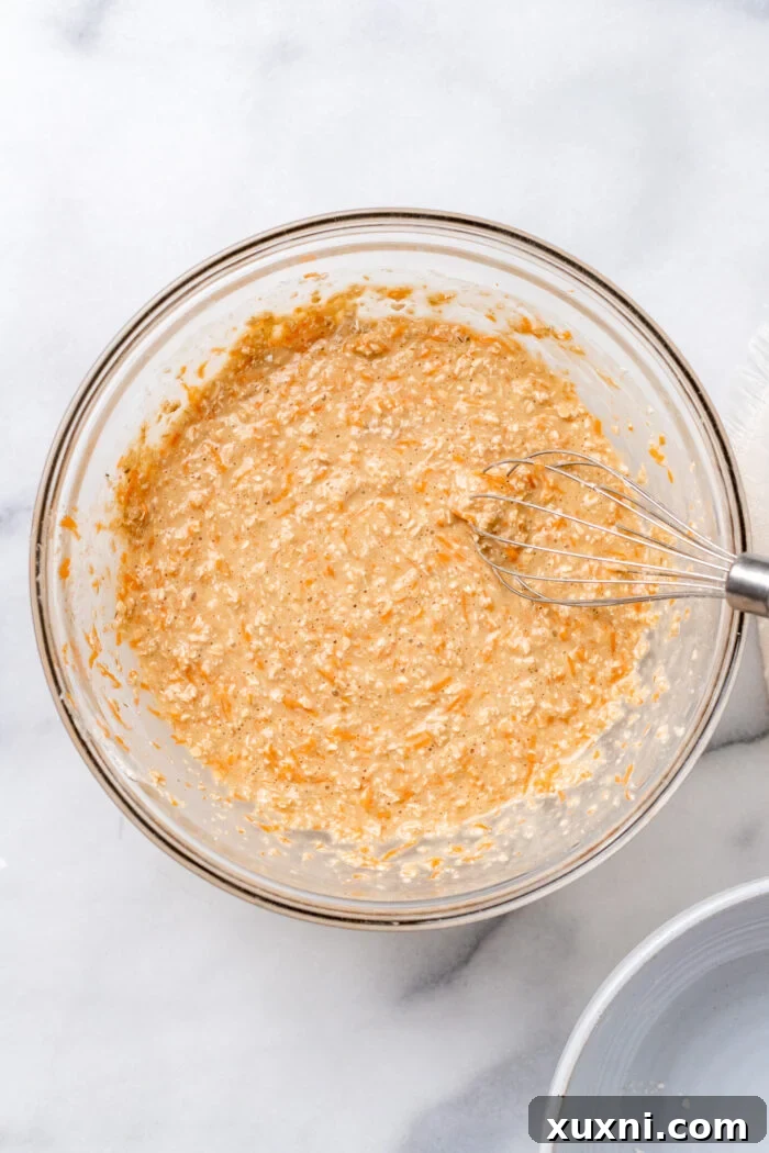 Carrot cake batter in a mixing bowl, ready to be poured.
