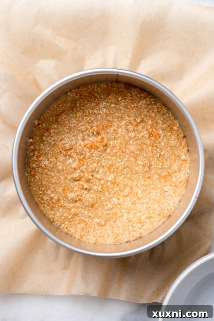 Unbaked carrot cake batter in a springform pan, pre-oven.