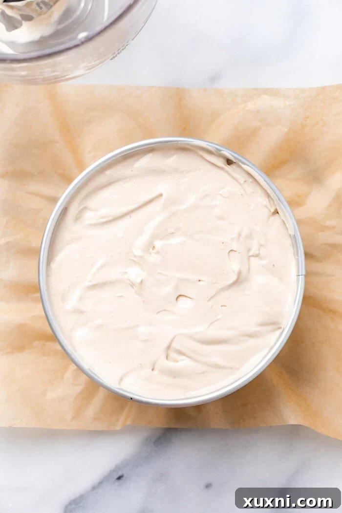 Cheesecake filling poured over the carrot cake base, pre-baking.