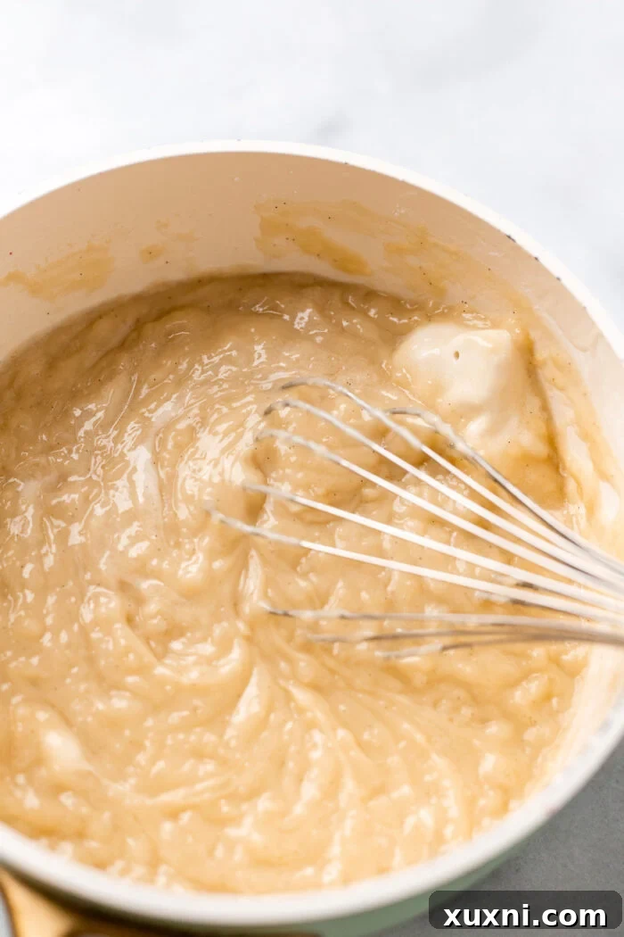 vegan butter in custard being whisked in