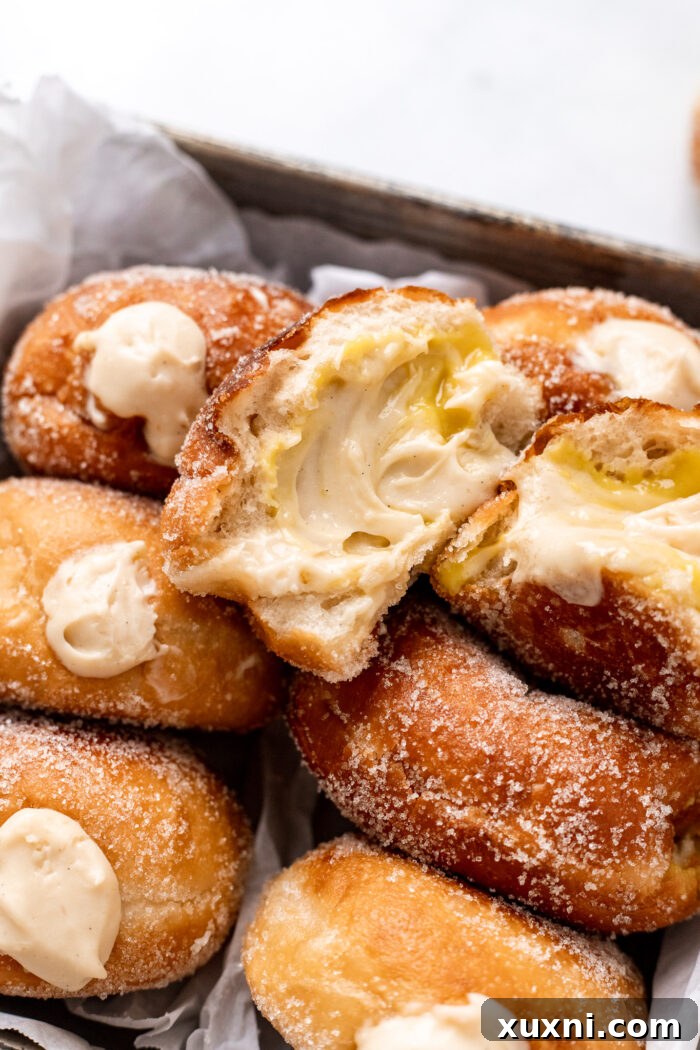torn open vegan doughnut with pastry cream