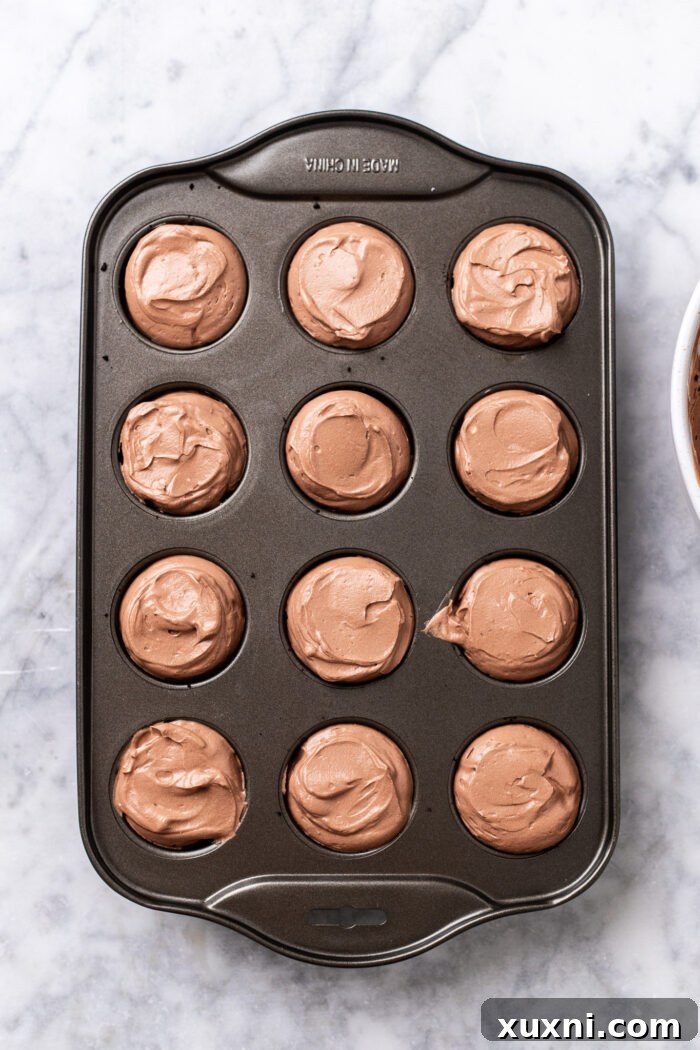 Easy No Bake Plant Based Chocolate Mini Cheesecakes 11 A tray of mini chocolate cheesecakes chilling in the freezer, ready to set.