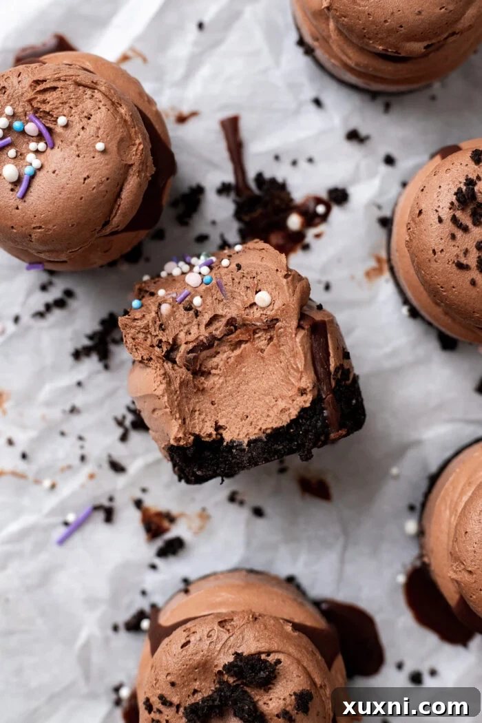 Easy No Bake Plant Based Chocolate Mini Cheesecakes 3 A perfectly bitten mini chocolate cheesecake revealing its creamy interior and crunchy Oreo crust.