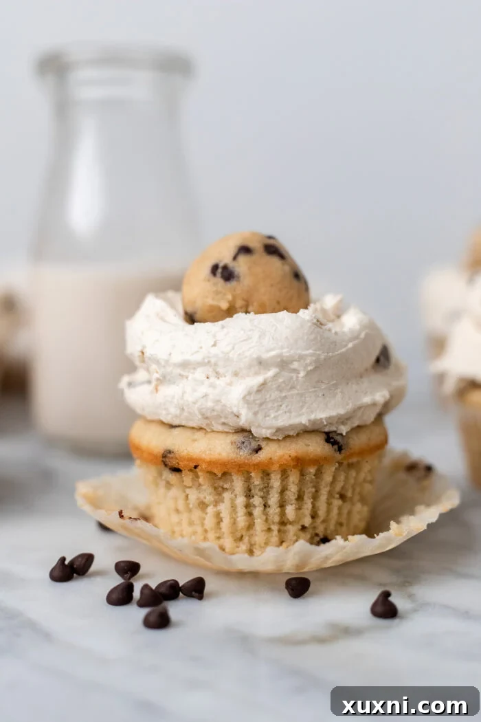Decadent molten cookie dough cupcake with wrapper peeled off, revealing the delicious texture
