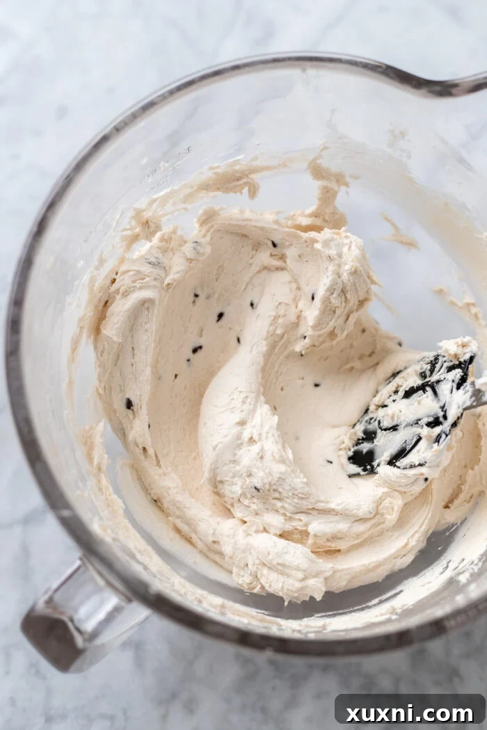 Fluffy cookie dough frosting in a mixing bowl, showcasing its smooth and creamy texture.
