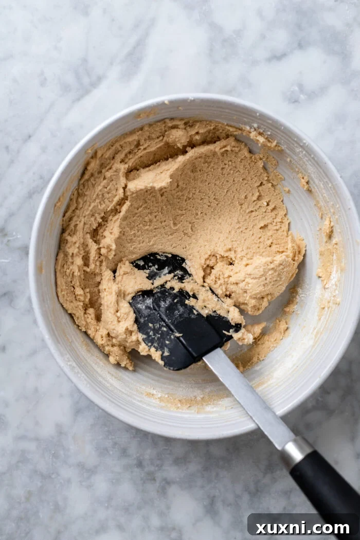 Cookie dough mixture before chocolate chips are added, showing its smooth consistency.