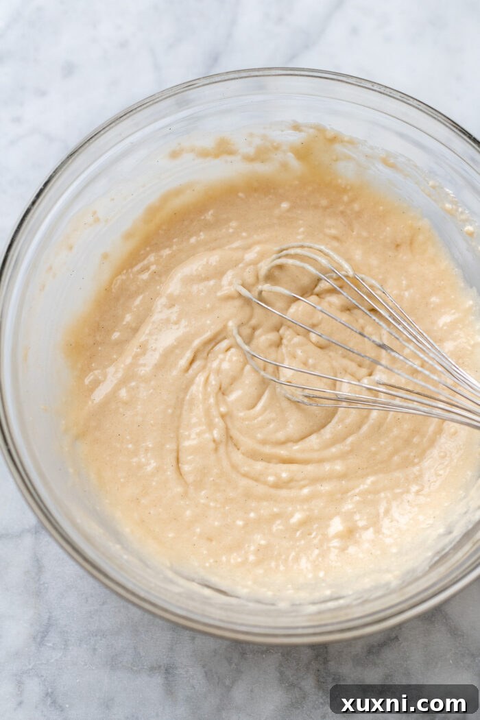 Cupcake batter in a bowl, before chocolate chips are folded in, showing a creamy consistency.