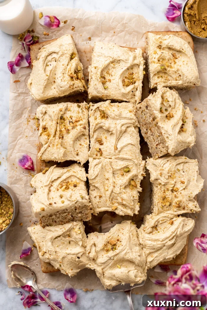 Sliced vegan pistachio sheet cake, showcasing its light green color and moist texture.