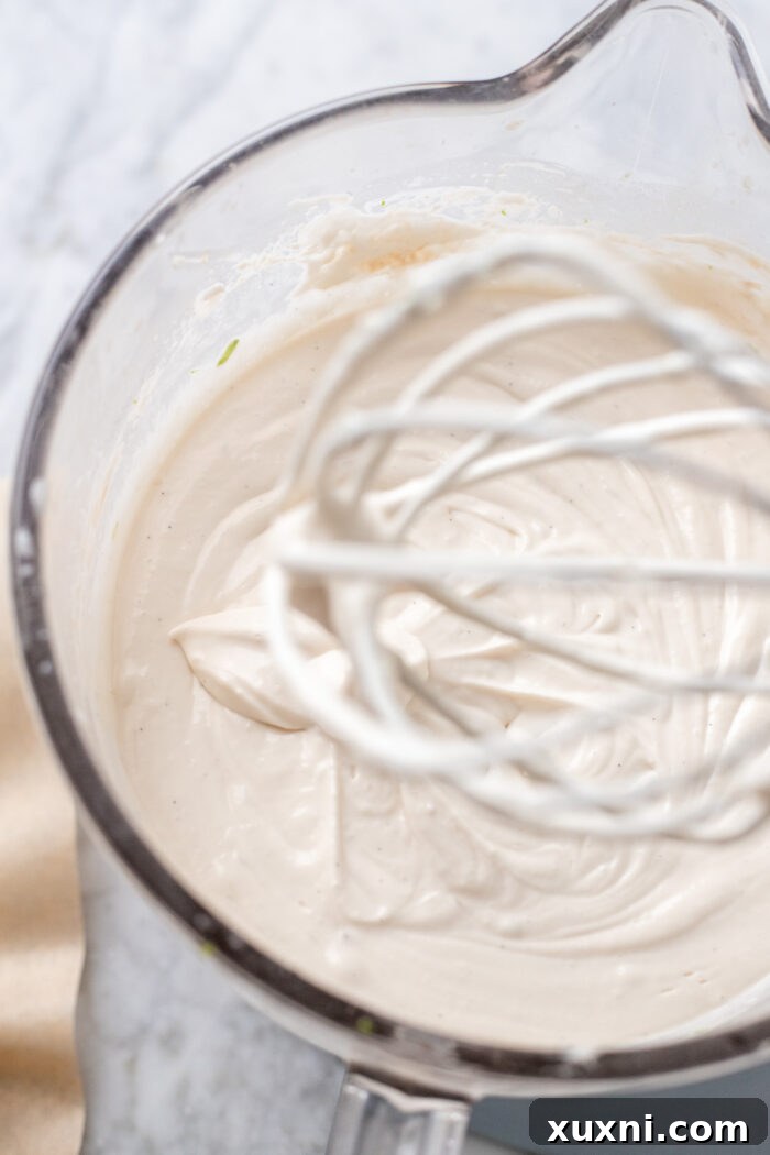 Key lime cheesecake batter thoroughly mixed in a stand mixer