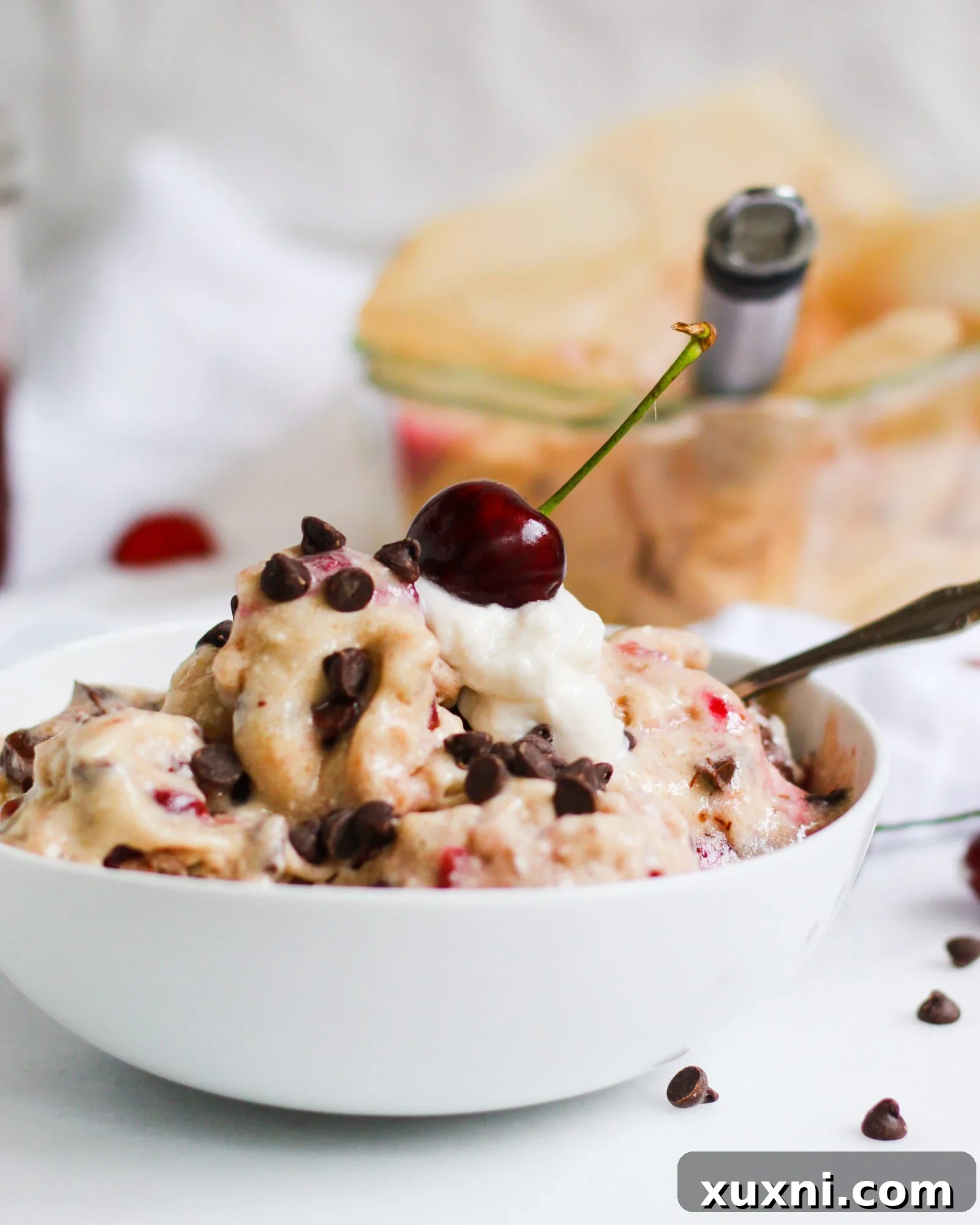 bowl of banana ice cream with cherry on top
