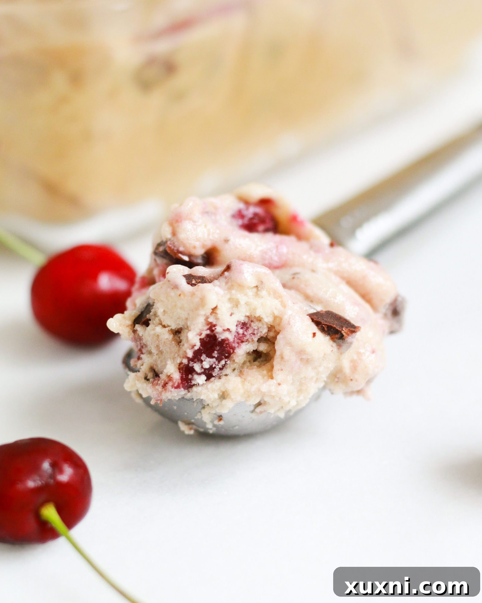scoop of cherry garcia ice cream on marble slab