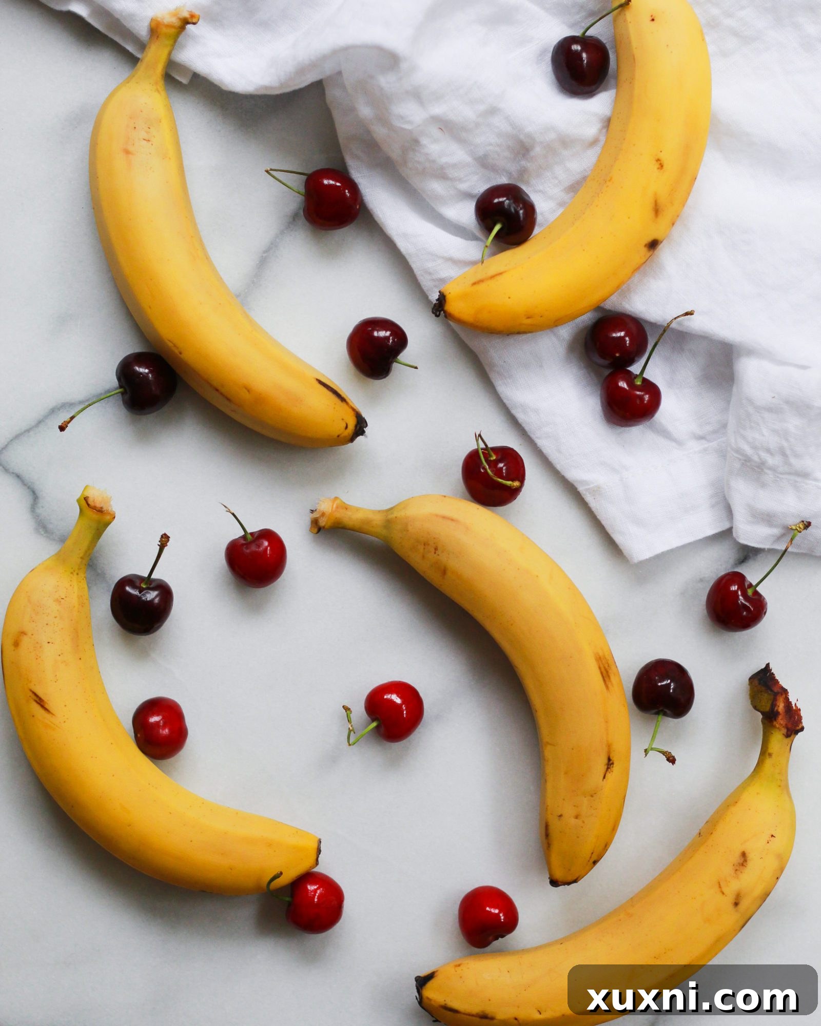 bananas and cherry on marble slab