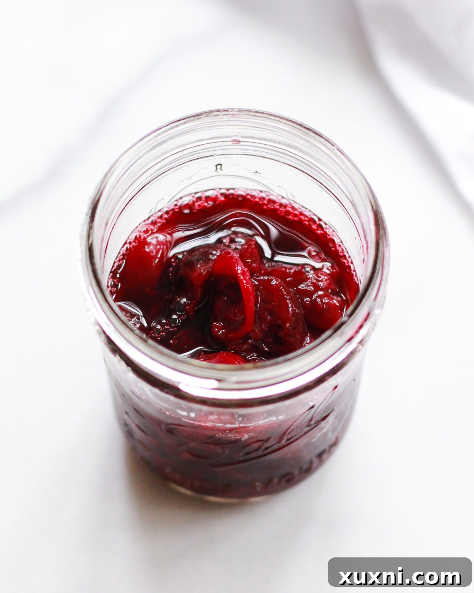 cooked and cooled cherries in jar
