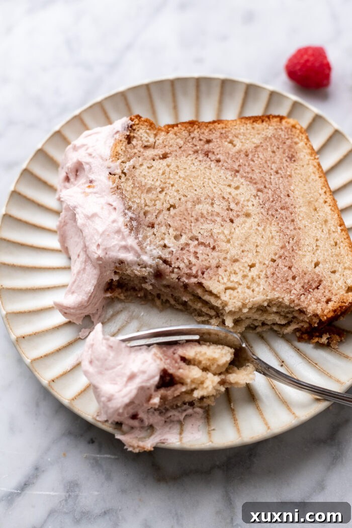 Sliced vegan raspberry pound cake showing intricate marble swirls