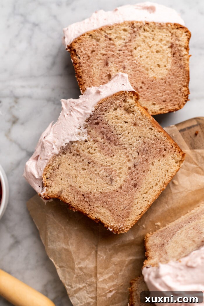 Close-up of a slice of vegan raspberry pound cake, showcasing the raspberry swirl