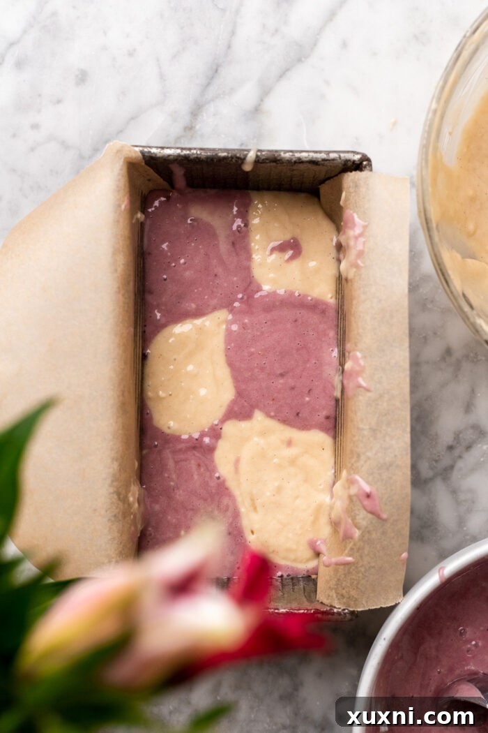 Assembling the raspberry pound cake batter in a loaf pan