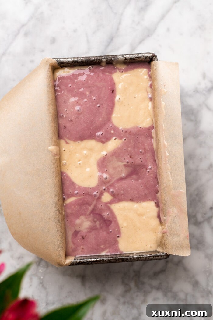 Continuing to assemble the raspberry pound cake batter in a loaf pan