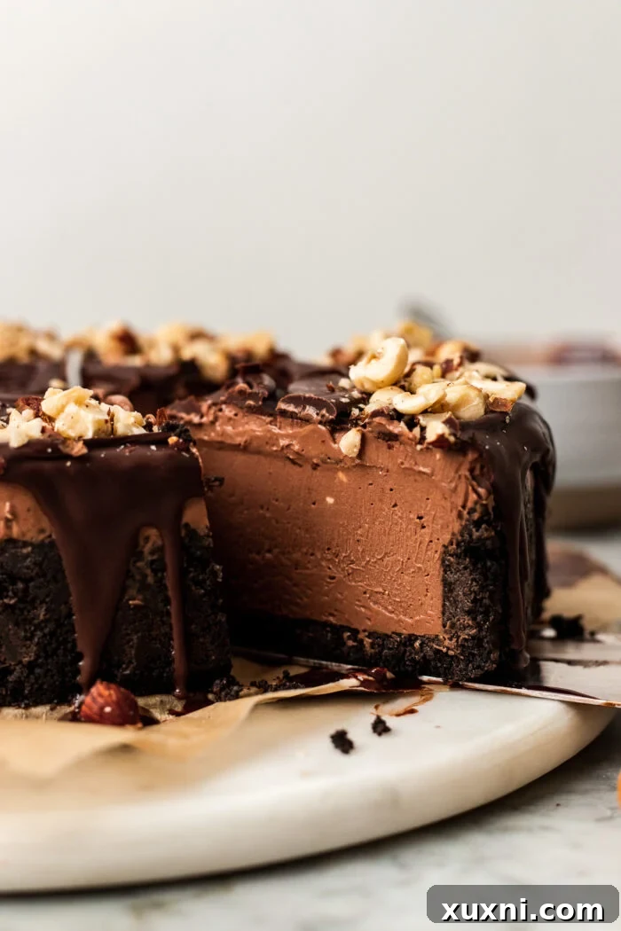 Sliced vegan no-bake Nutella cheesecake on a plate, showing its creamy texture and Oreo crust