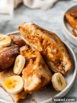 close up of French toast with peanut butter and banana on a plate
