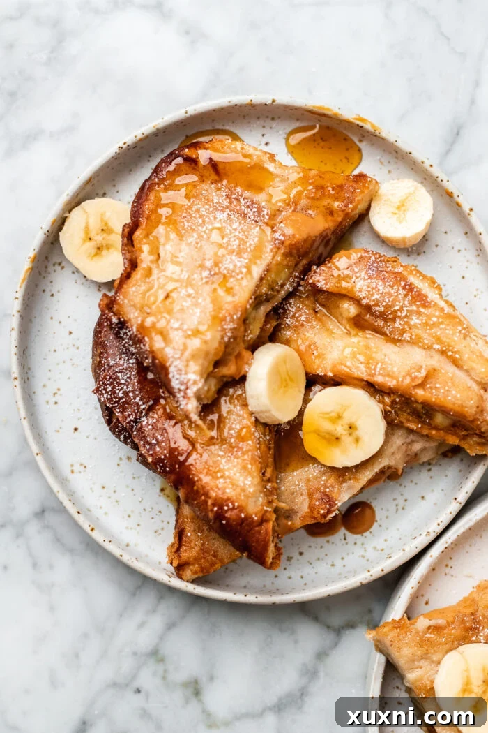 plate of stuffed French toast with bananas