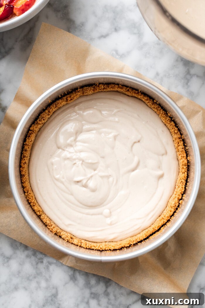 First layer of vegan cheesecake batter poured over the cookie crust in a springform pan.