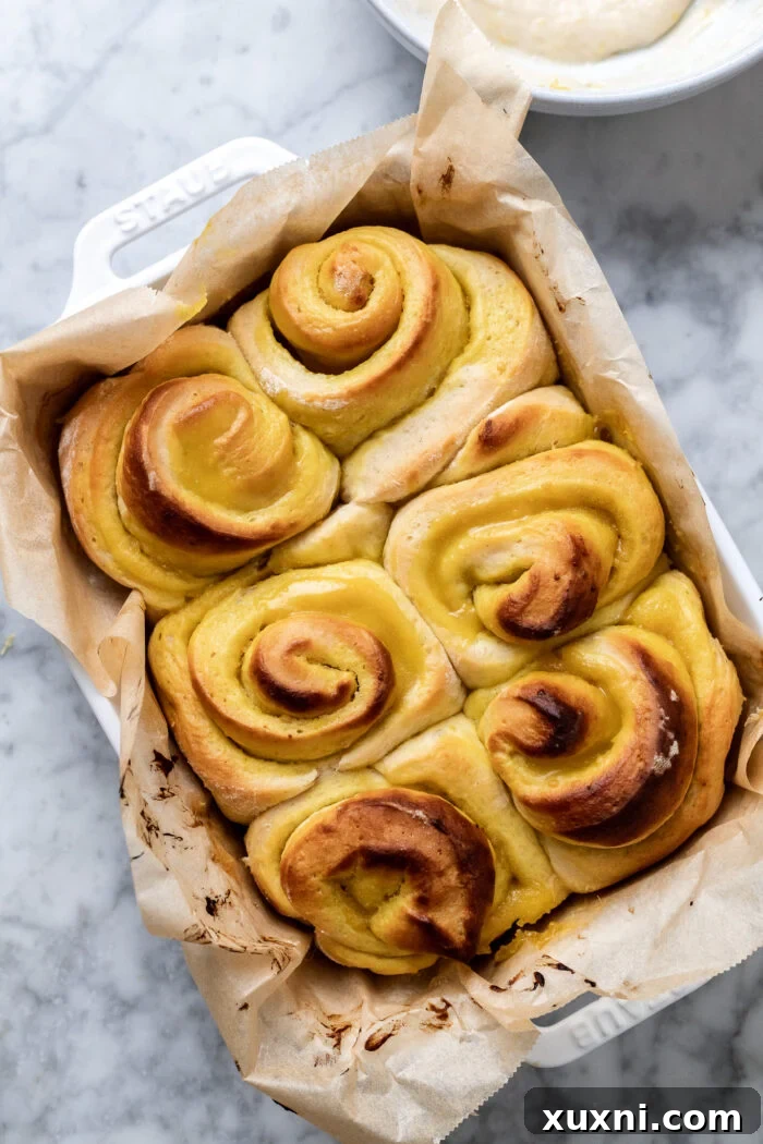 Small Batch Gooey Lemon Sweet Rolls Plant Based 13 Freshly baked lemon sweet rolls, golden brown and still in the casserole dish, some with visible lemon curd.