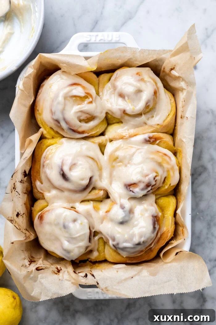 Small Batch Gooey Lemon Sweet Rolls Plant Based 14 Close-up of frosted vegan lemon sweet rolls in a casserole dish, ready to be served.