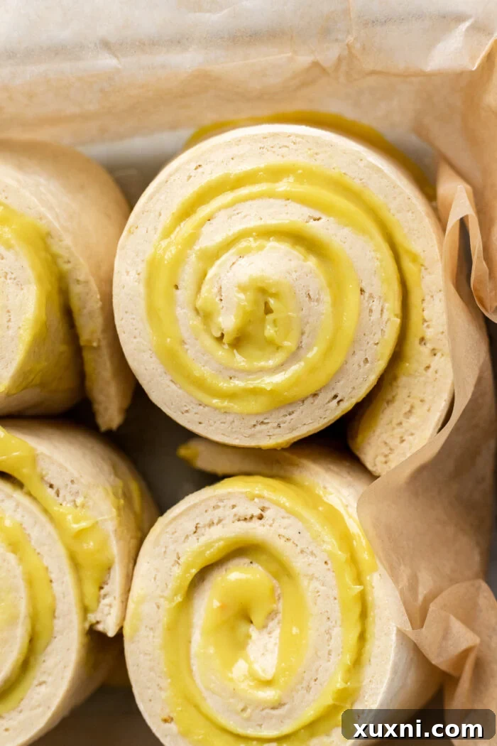 Small Batch Gooey Lemon Sweet Rolls Plant Based 16 Gluten-free lemon sweet rolls, risen and ready for baking in a casserole dish.