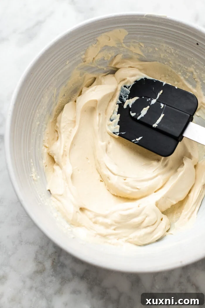 A bowl of freshly blended, smooth vegan mascarpone, ready for storage.