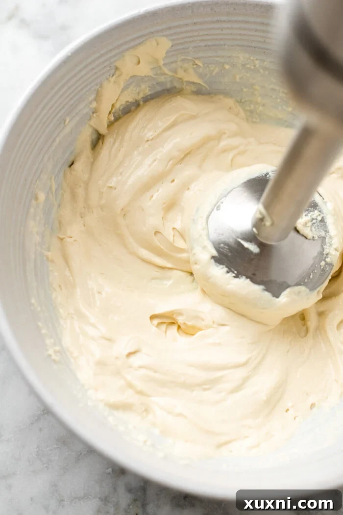 Vegan mascarpone being blended in a food processor until smooth and creamy.