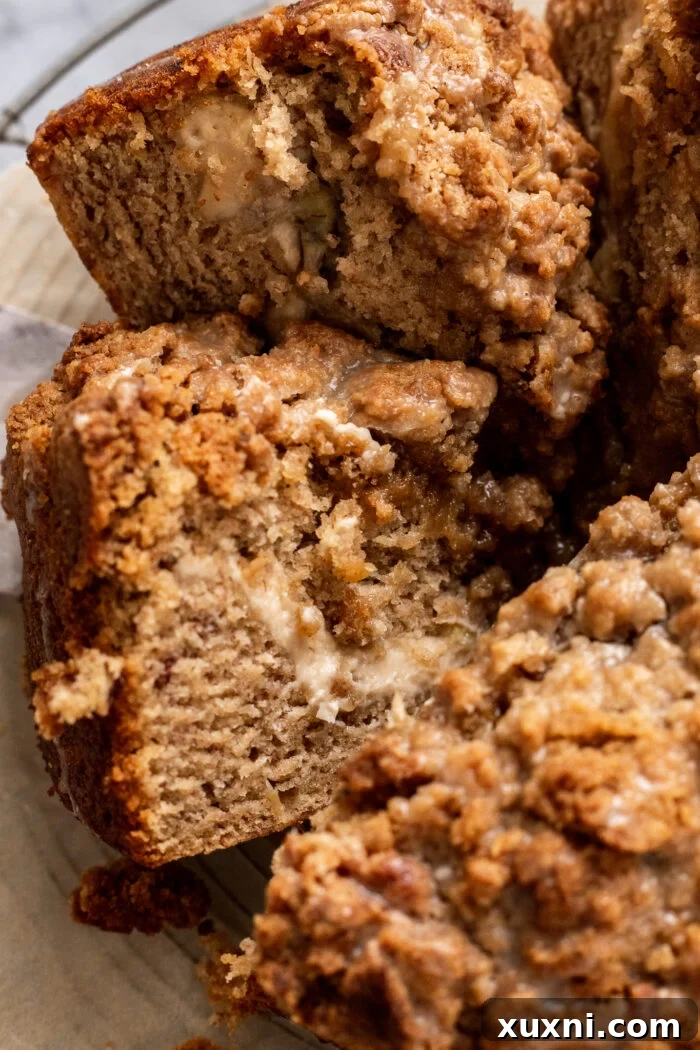 Multiple slices of vegan banana coffee cake arranged on a marble surface, highlighting the layers and crumb topping.