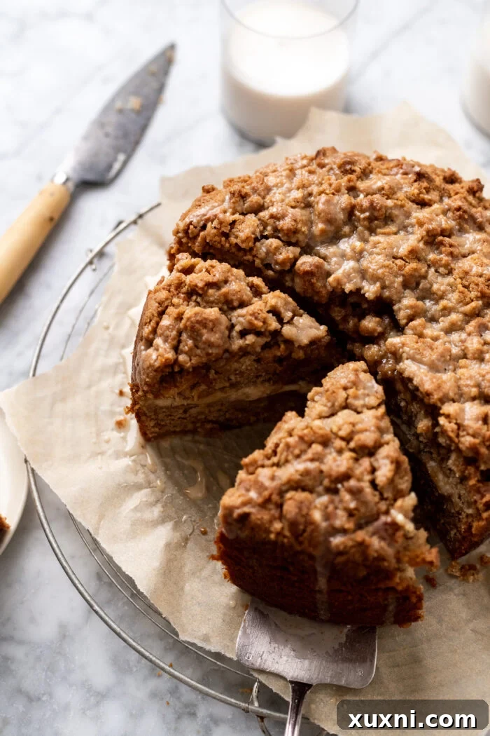 Several slices of vegan banana coffee cake with a creamy cream cheese filling, resting on a marble surface.