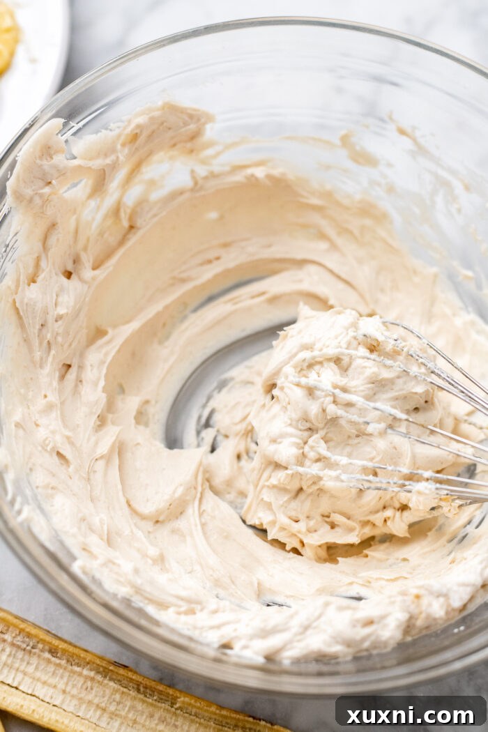 Creamy vegan cream cheese filling in a mixing bowl, ready for assembly.