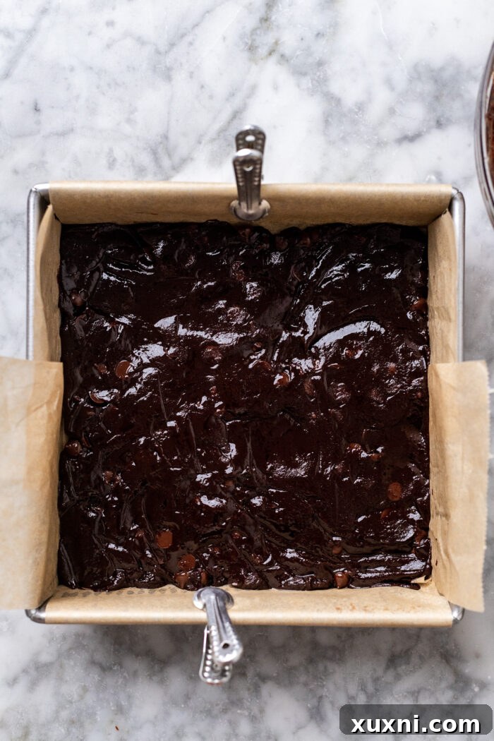 half of the cookie dough pressed into the pan
