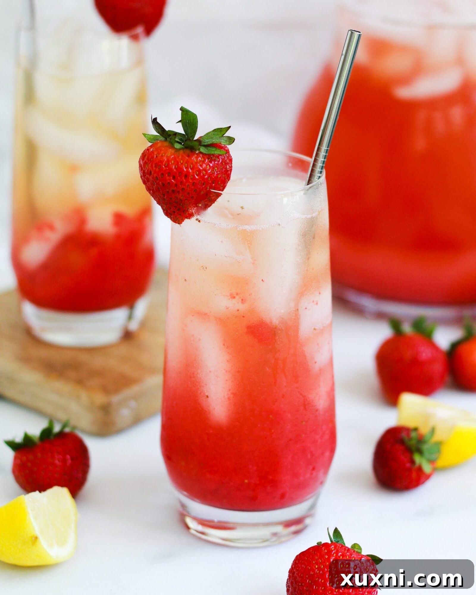 A glass of perfectly mixed Iced Strawberry Green Tea Lemonade, ready to be enjoyed