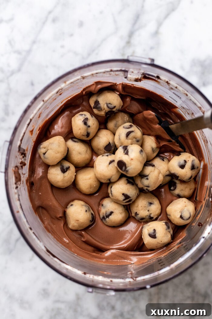 Easy No-Bake Vegan Brownie-Cookie Dough Cheesecake Bars 8 cookie dough balls in brownie cheesecake batter