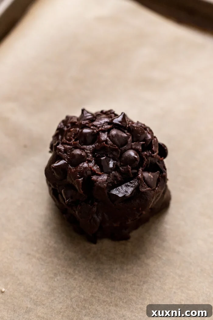 The perfectly formed single serving double chocolate chip cookie dough, ready for chilling and baking on a baking sheet.